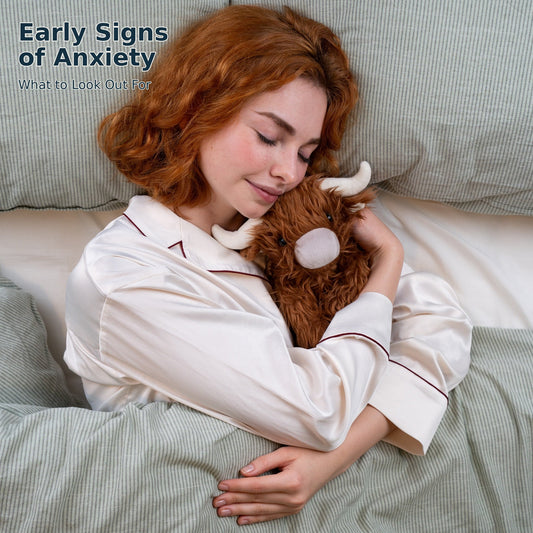 Picture of a woman cuddling a McCuddles weighted Highland Cow