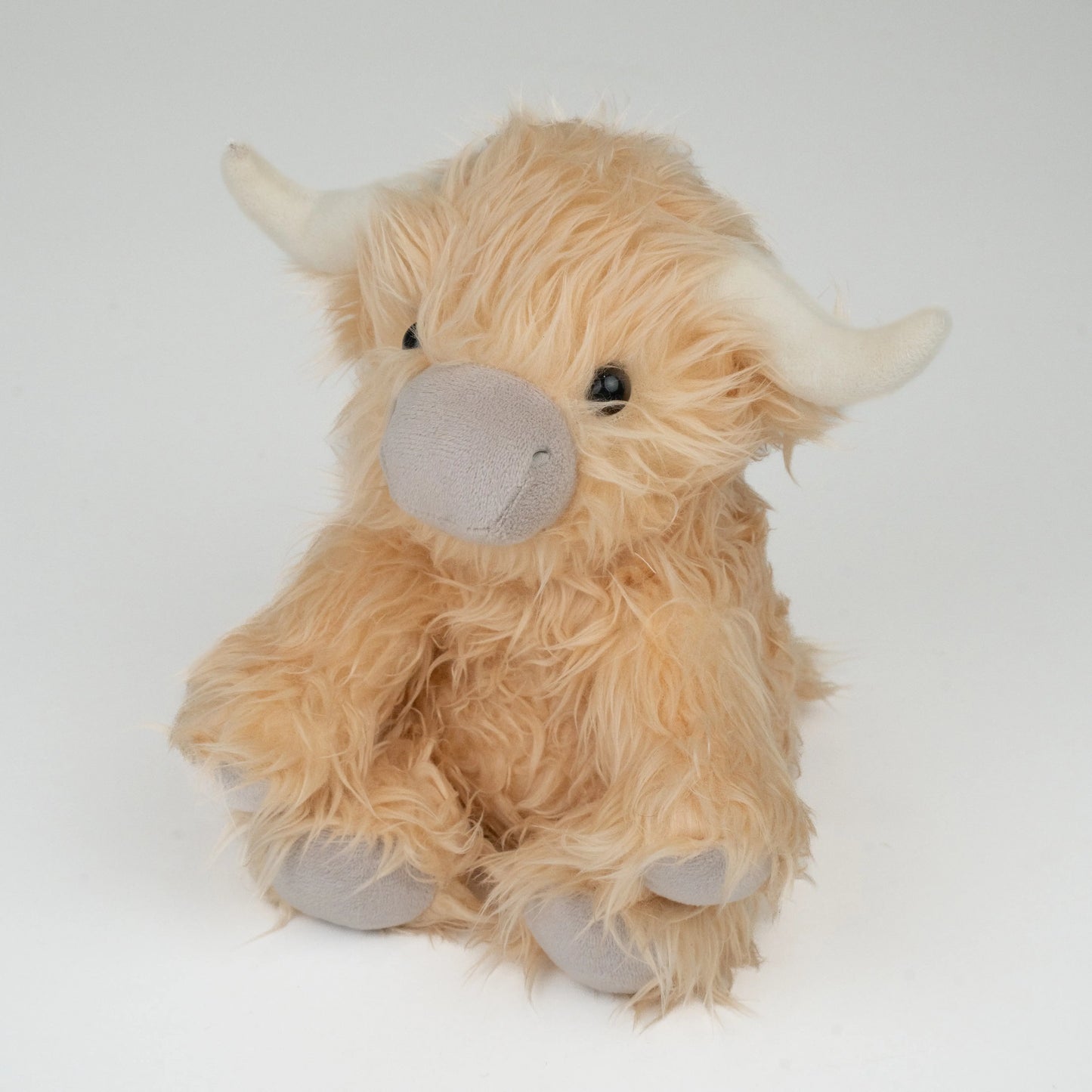 Marmalade the weighted Highland cow plush for anxiety relief and heat therapy.